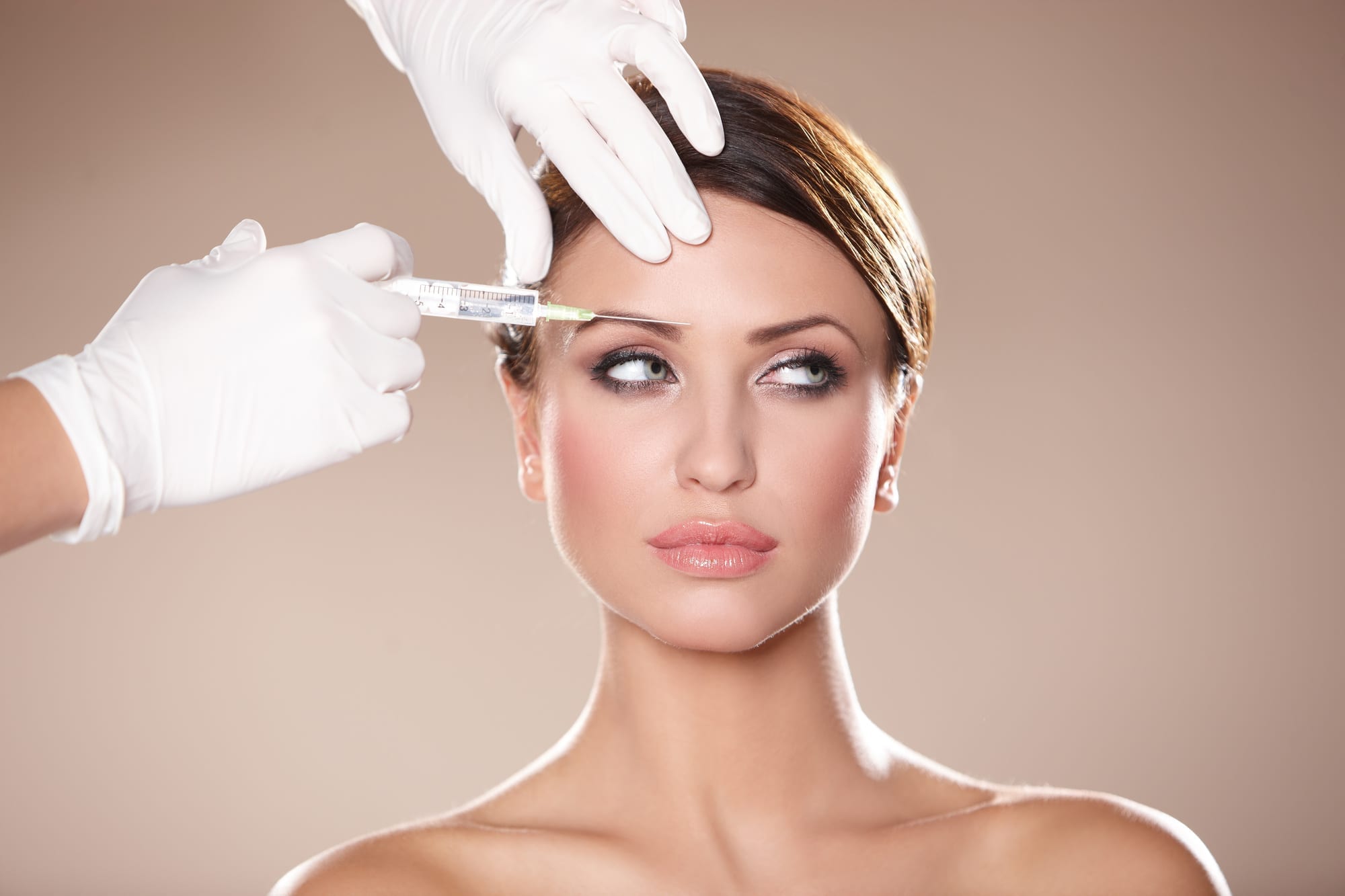 Beautiful woman gets botox injection in her face